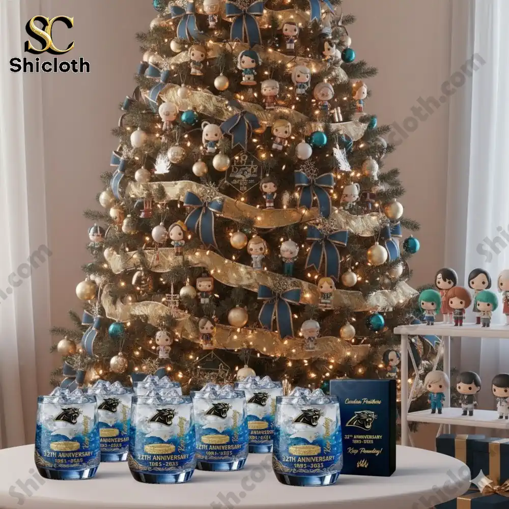 Christmas tree decorated with many small character ornaments and Carolina Panthers anniversary glasses displayed in front.