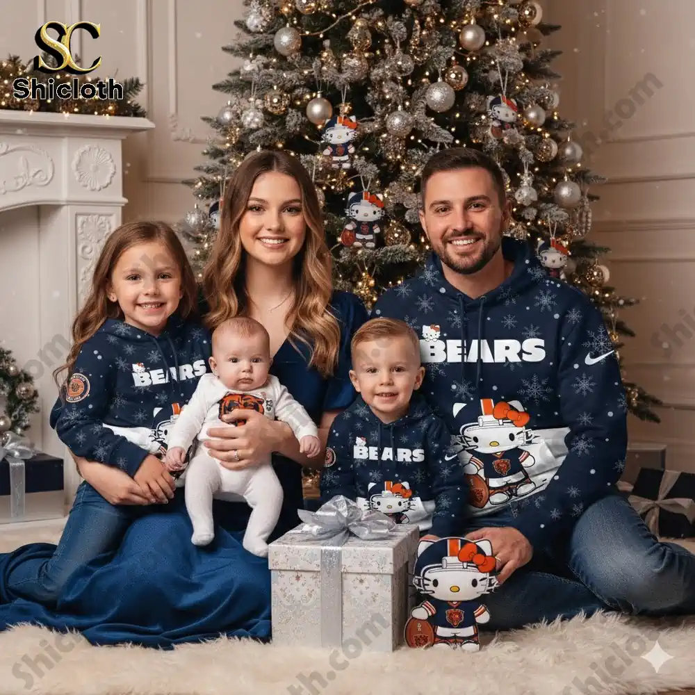 A family wearing Chicago Bears themed Hello Kitty hoodies, sitting together by a Christmas tree with a gift box in the foreground.