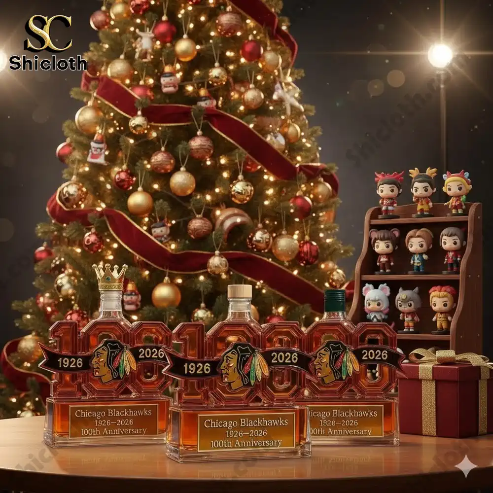 Three Chicago Blackhawks 100th Anniversary whiskey bottles displayed in front of a decorated Christmas tree.