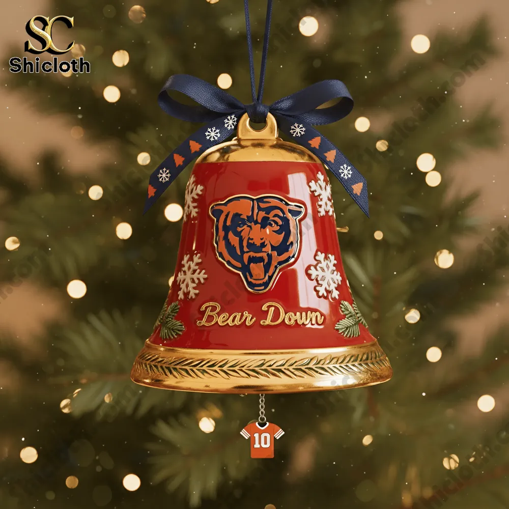 A close-up of a red Chicago Bears Christmas bell ornament with white snowflakes, a navy bow, and the phrase Bear Down.