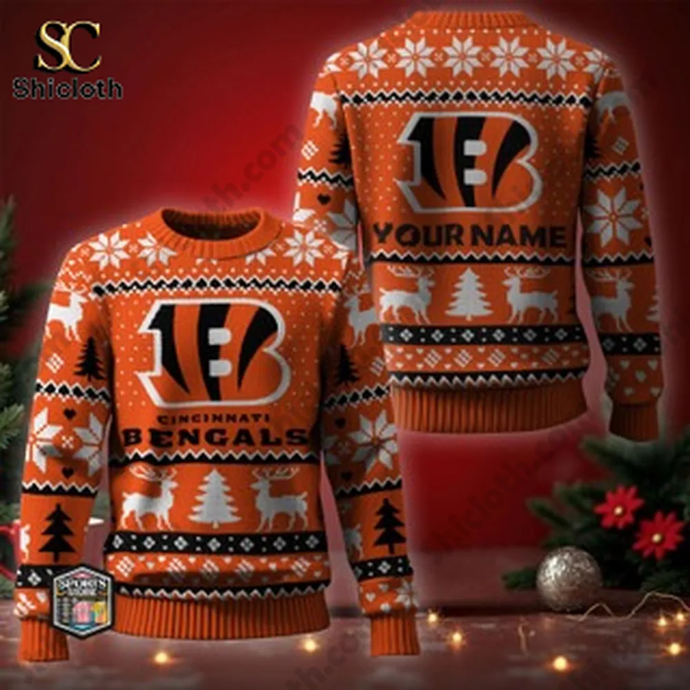 A Bengals themed Christmas sweater with customizable name on the back displayed in front of a Christmas tree and festive decor.