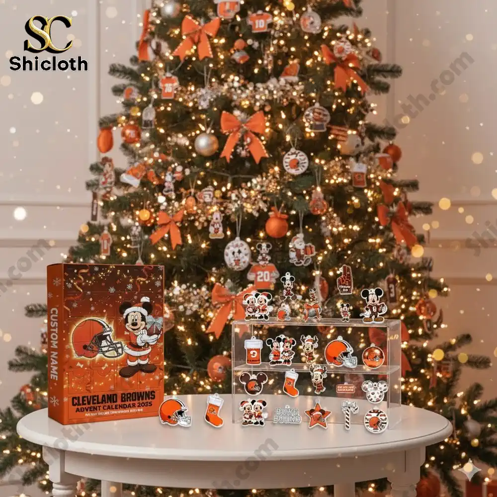 A decorated Christmas tree with Cleveland Browns ornaments and a Shicloth Advent Calendar 2025 on the table.