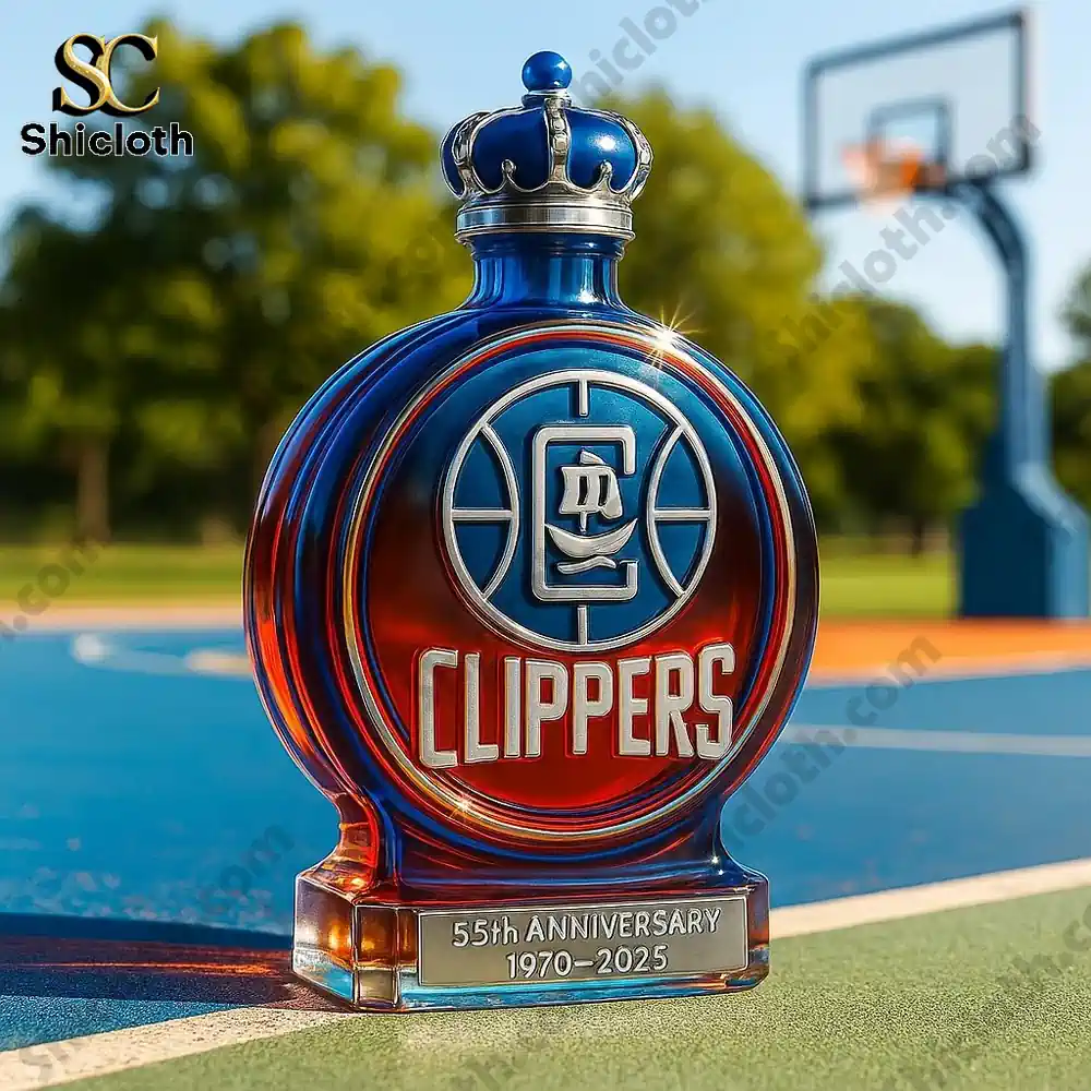 A Clippers 55th Anniversary whiskey bottle with a crown cap, placed on a basketball court backdrop.