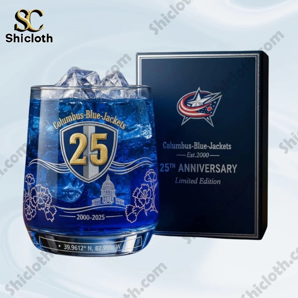 A Shicloth Columbus Blue Jackets twenty five anniversary glass filled with blue liquid beside a matching presentation box.