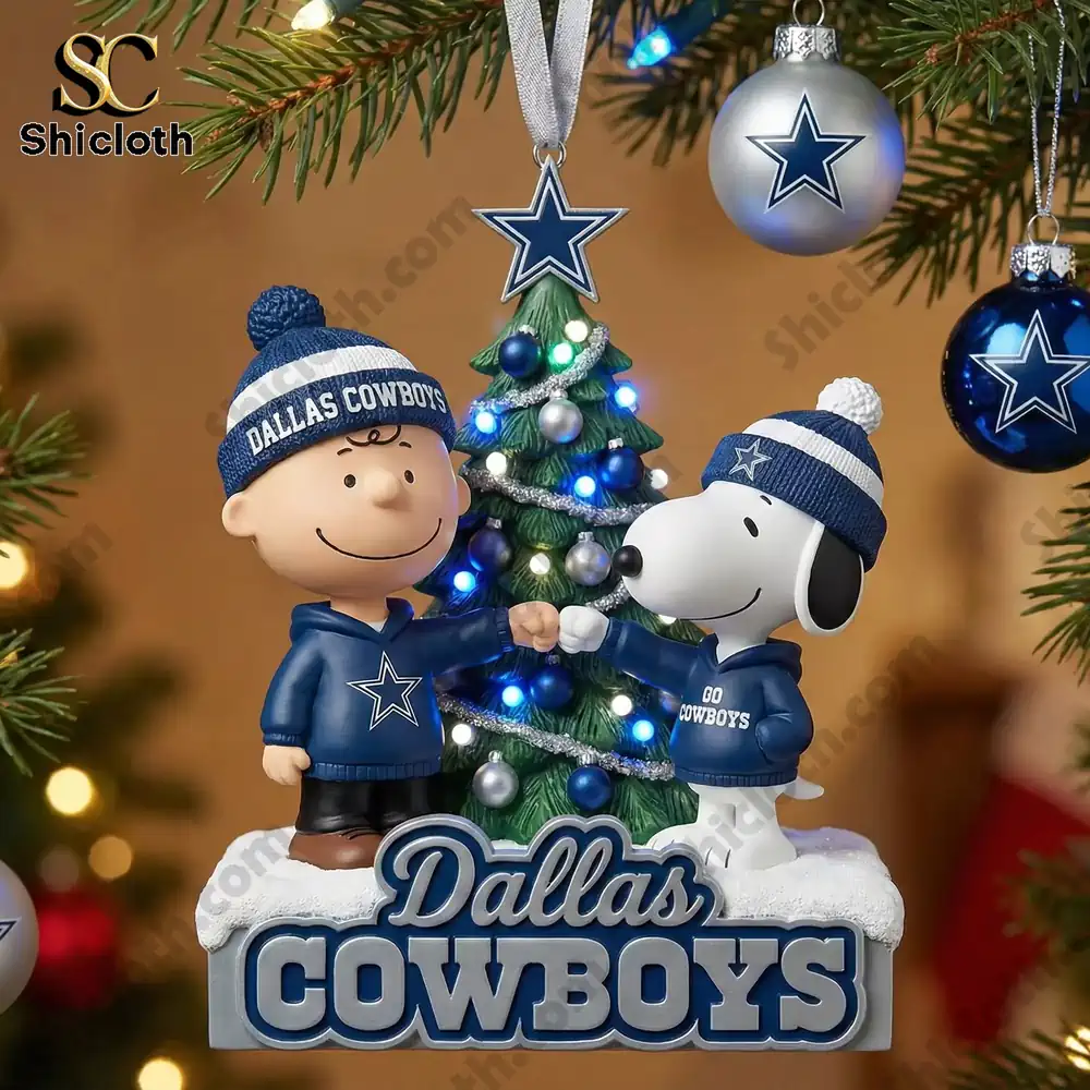 Dallas Cowboys ornament with two cartoon characters fist bumping near a small lit tree.
