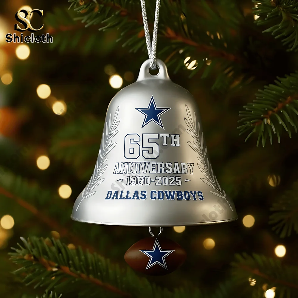 Close up of a Dallas Cowboys 65th anniversary silver Christmas bell ornament hanging on a tree.