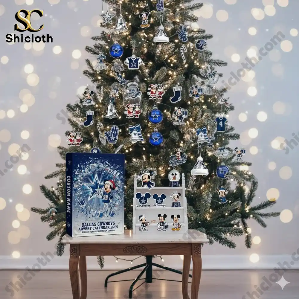 A Christmas tree decorated with Dallas Cowboys ornaments and a Shicloth Advent Calendar 2025 on a wooden table.