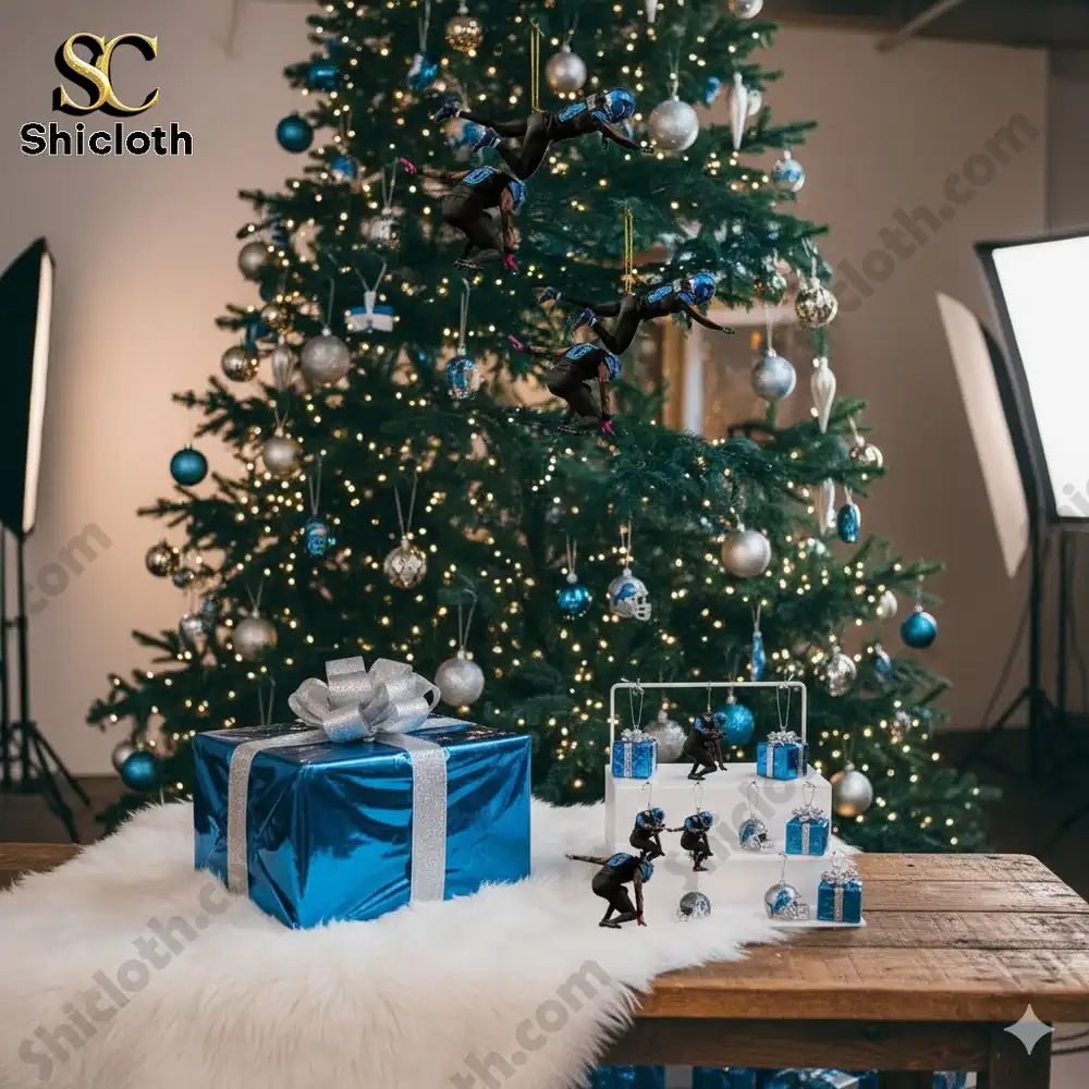 A decorated Christmas tree with Detroit Lions-themed football ornaments and a blue gift box beneath it.