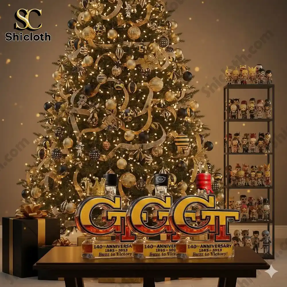 A glowing holiday tree with gold ornaments behind a GT anniversary whiskey bottle display.