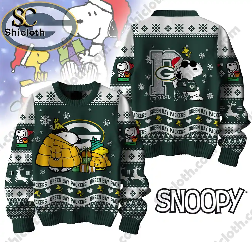 A Green Bay Packers-themed Christmas sweater featuring Snoopy in a festive holiday design with snowflakes and Packers branding.