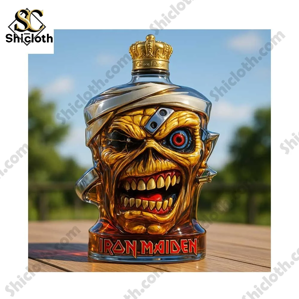 A single golden monster head bottle with a crown sitting on a wooden surface outdoors.