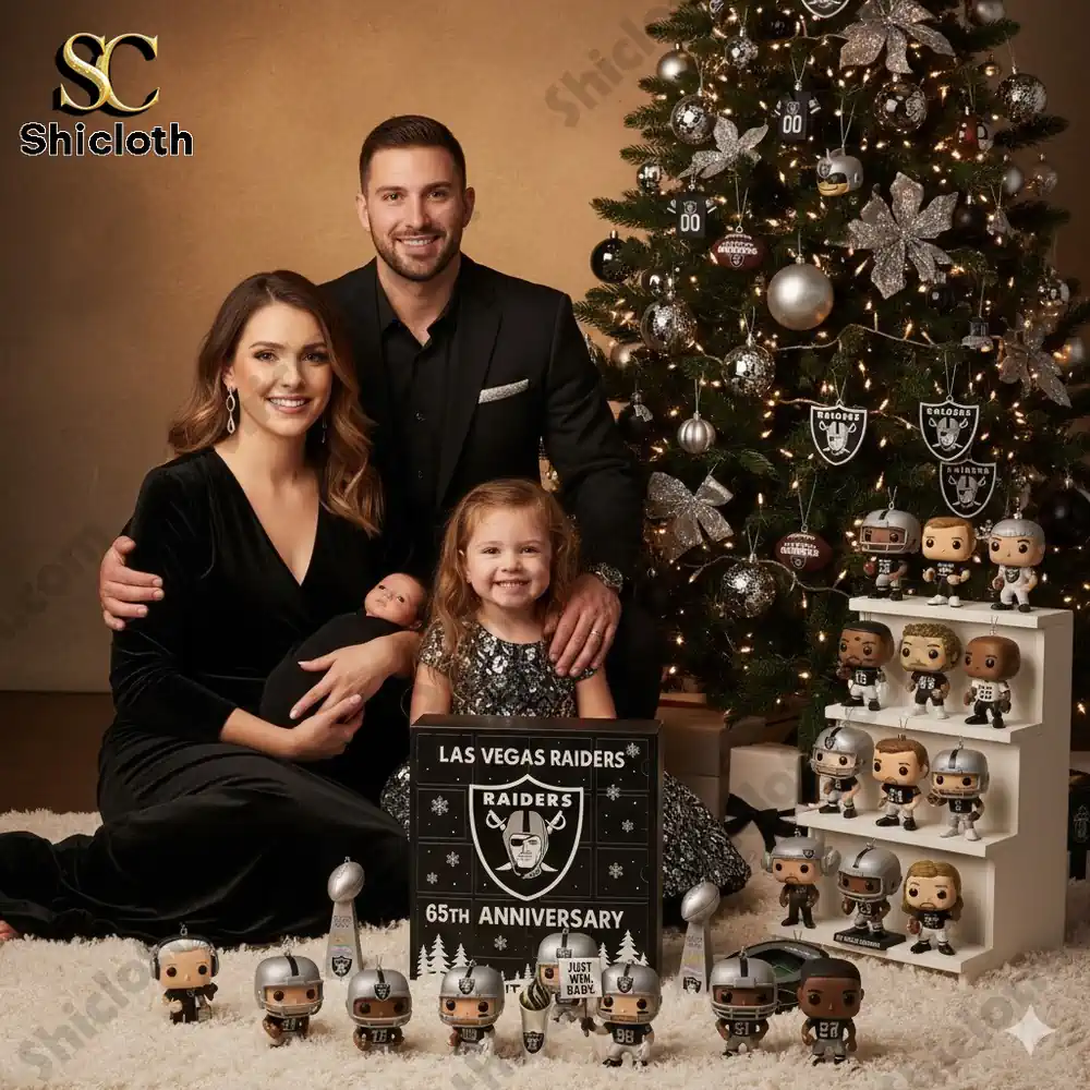A family posing beside a Christmas tree decorated with Las Vegas Raiders themed ornaments and a 65th Anniversary advent calendar box.