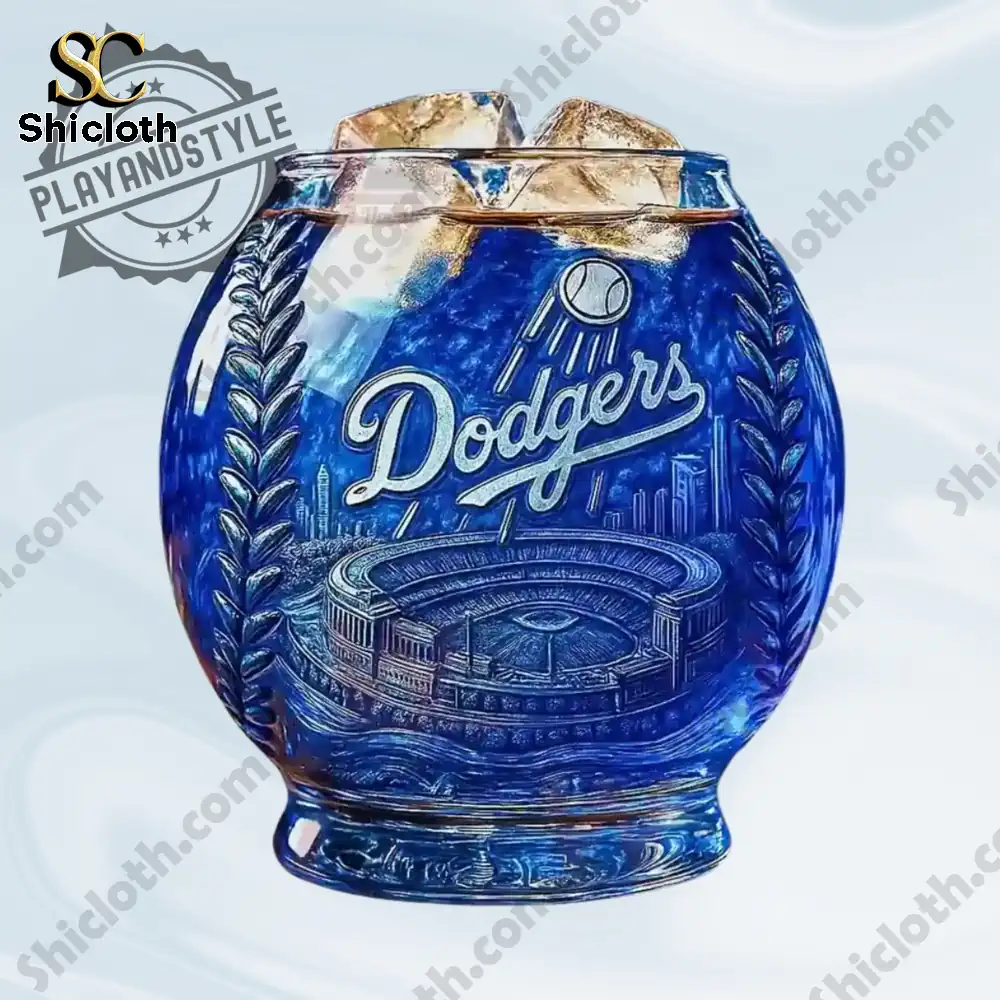A blue Dodgers themed round drinking glass with carved stadium art sits filled with ice.