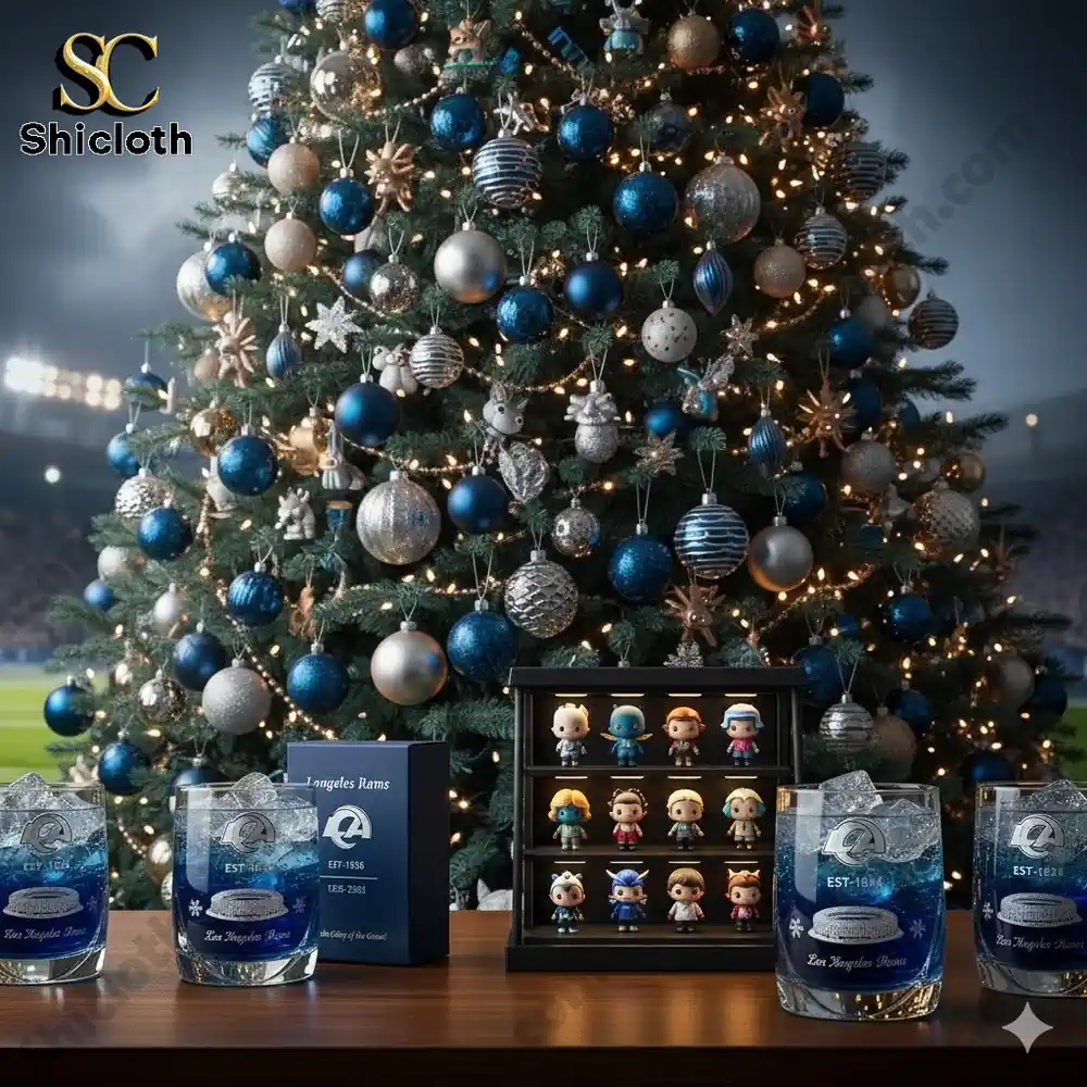 A decorated blue and silver Christmas tree beside collectible figures and Los Angeles Rams themed glasses on a wooden table!