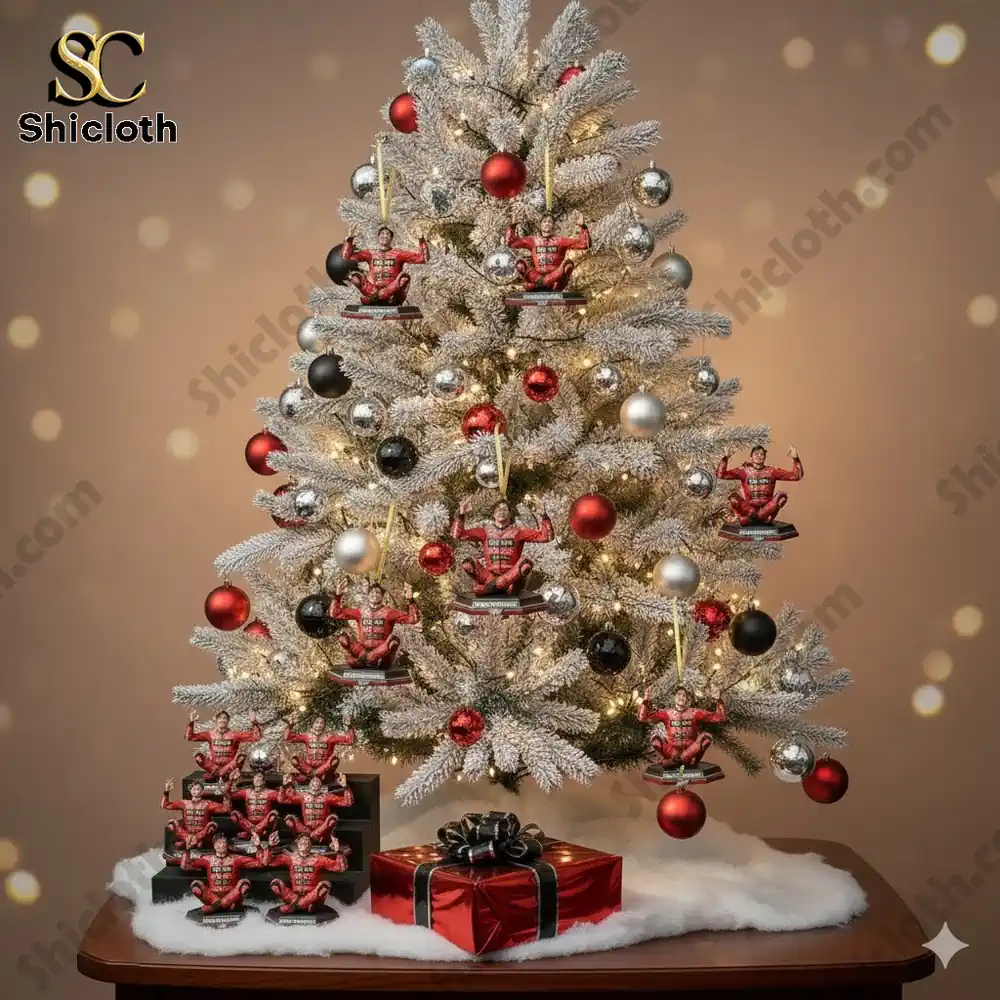 A decorated Christmas tree with Marc Marquez figures hanging as ornaments along with red, silver, and black baubles on white branches.
