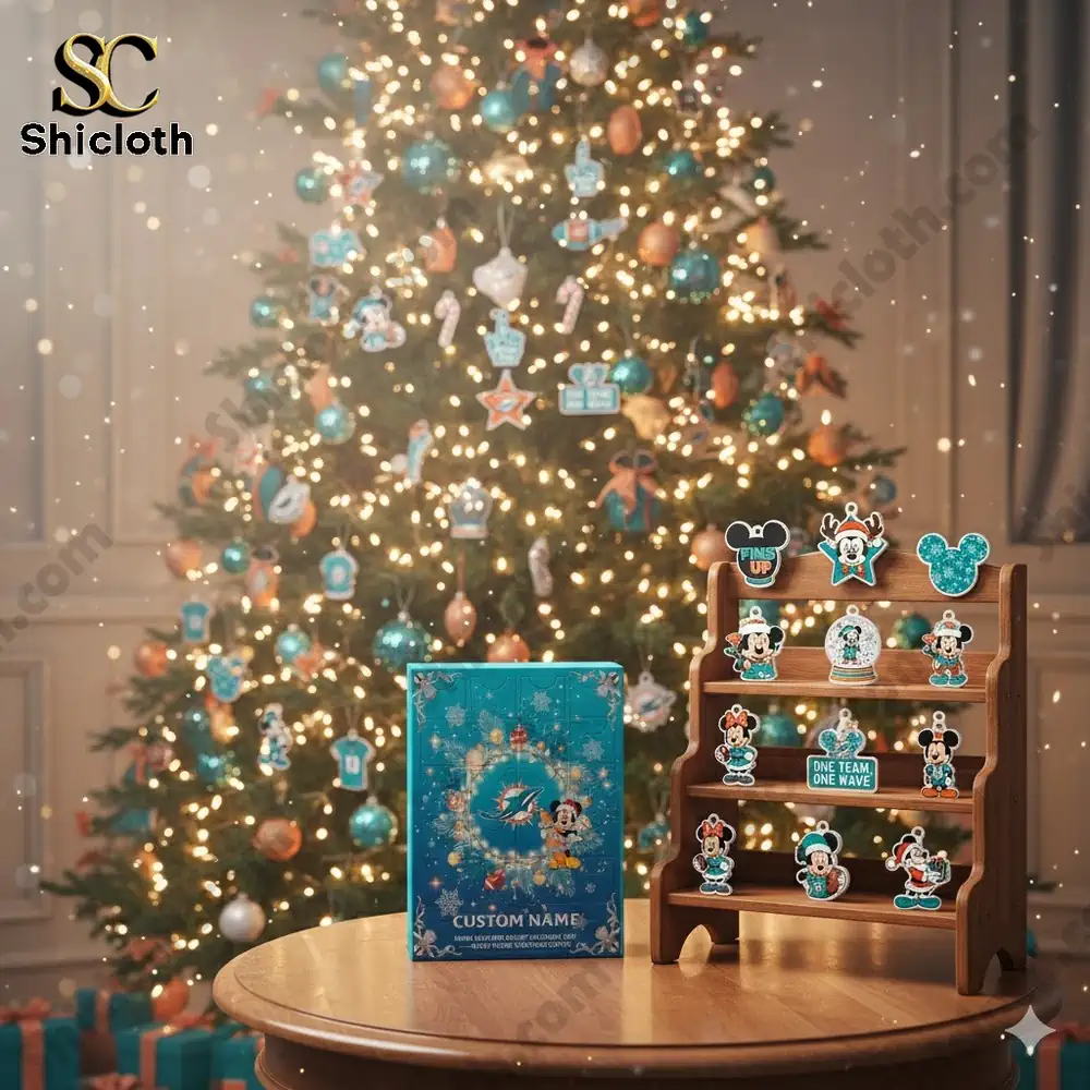 A decorated Christmas tree with Miami Dolphins themed ornaments and an advent calendar box on a table.