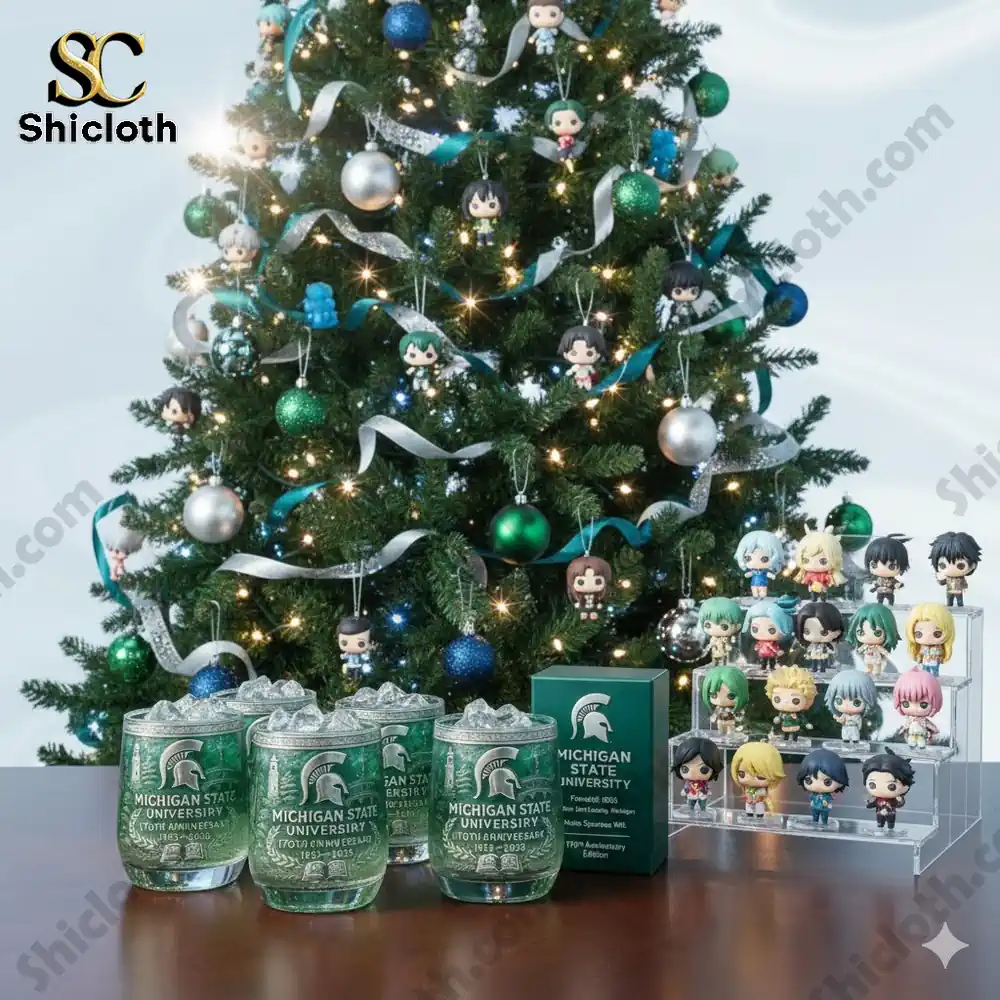 Christmas tree decorated with small character ornaments and Michigan State University anniversary glasses on a table.