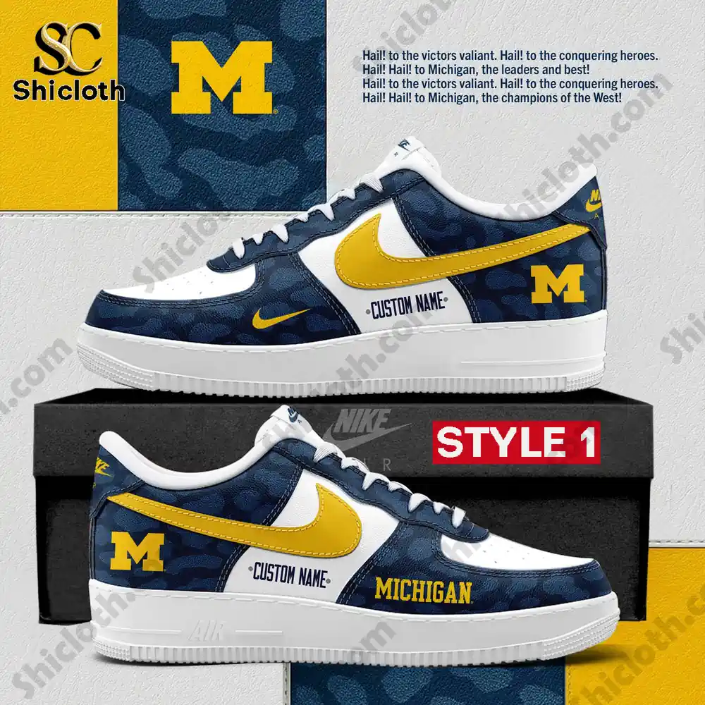 Blue and white Michigan themed sneakers with a bold yellow logo and camo pattern displayed on a box.