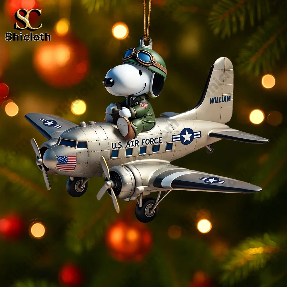 Military pilot sitting on a vintage fighter plane ornament.