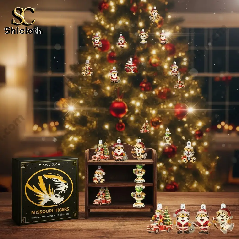 A set of Missouri Tigers themed Christmas ornaments displayed in front of a decorated Christmas tree.