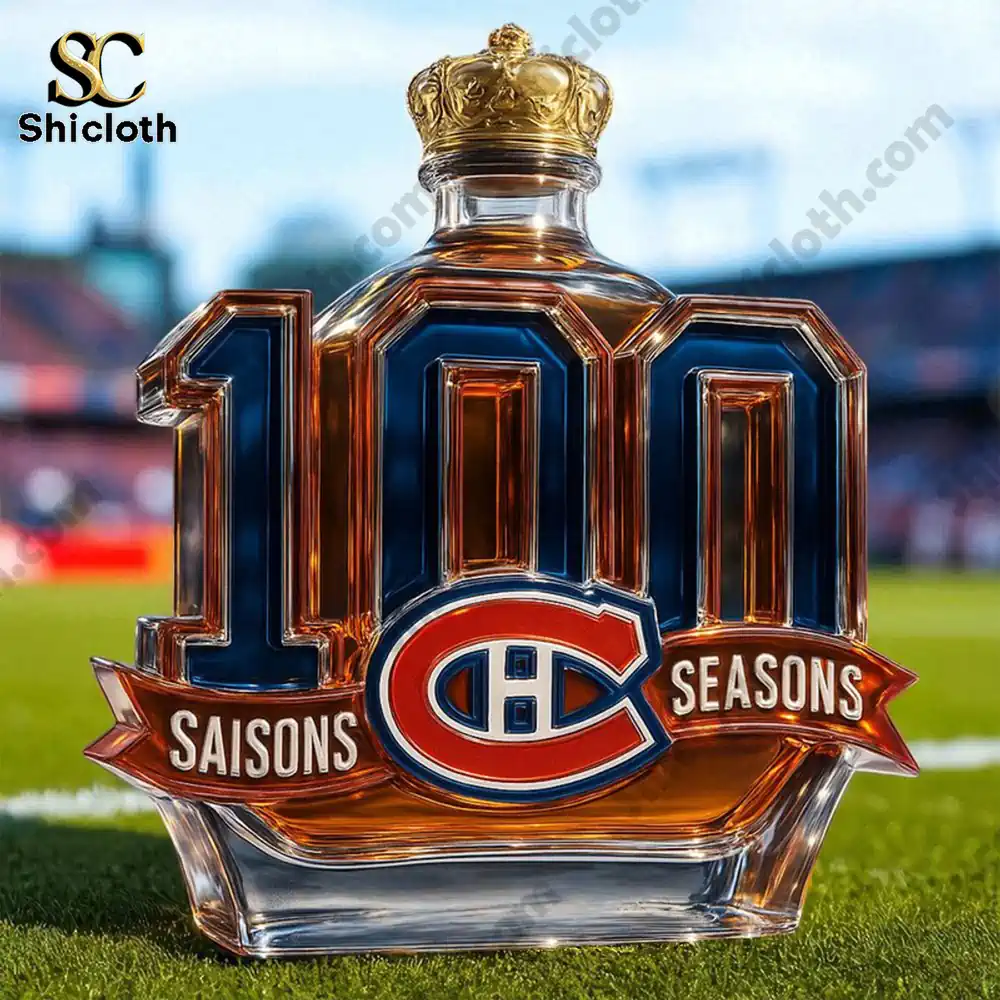 One hundred seasons Montreal bottle with a gold top on a field.
