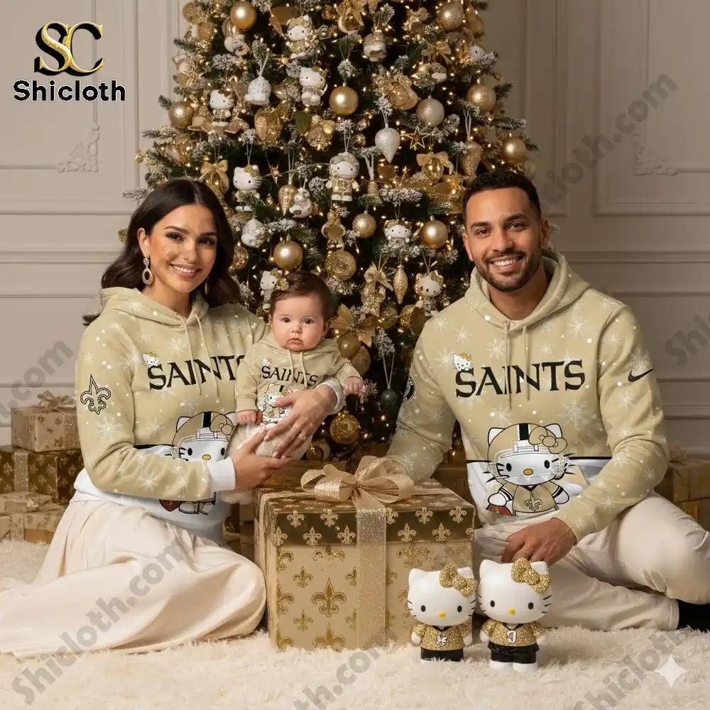 A family posing in front of a Christmas tree, wearing matching Hello Kitty-themed New Orleans Saints hoodies.