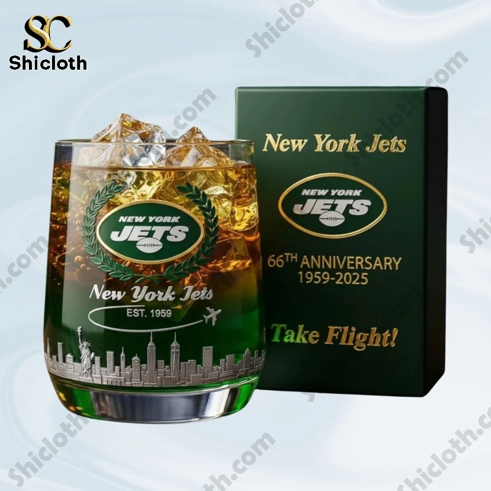 A New York Jets anniversary glass filled with ice next to a green gift box.