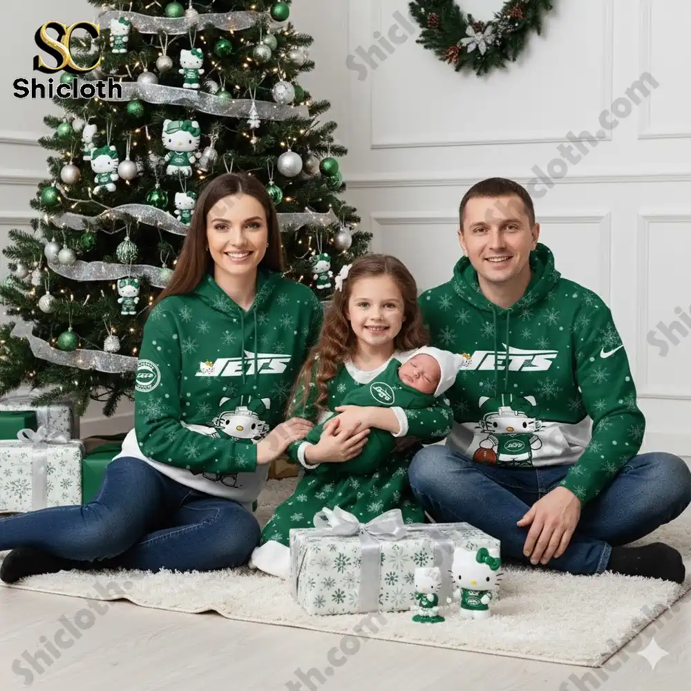 A family wearing matching New York Jets hoodies with Hello Kitty characters, sitting in front of a Christmas tree.