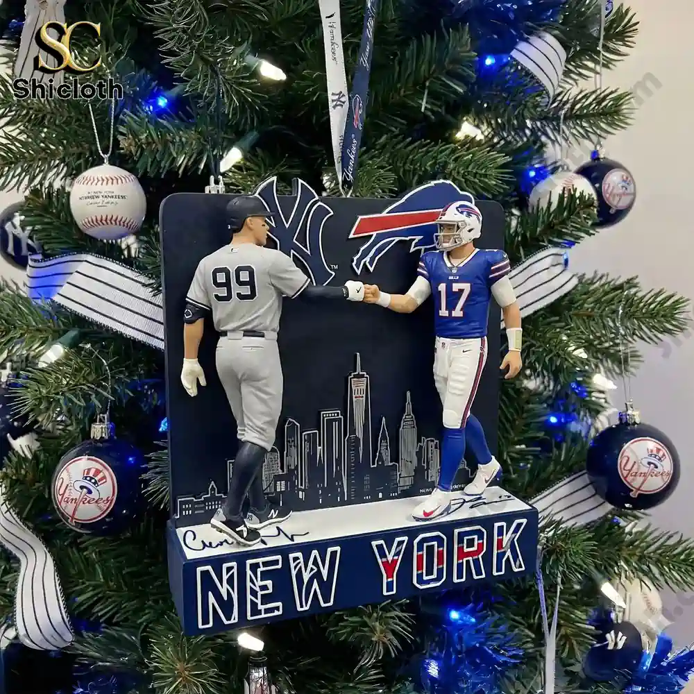Close up of a Christmas ornament showing a Yankees player figure and a Bills player figure greeting on a decorated tree!