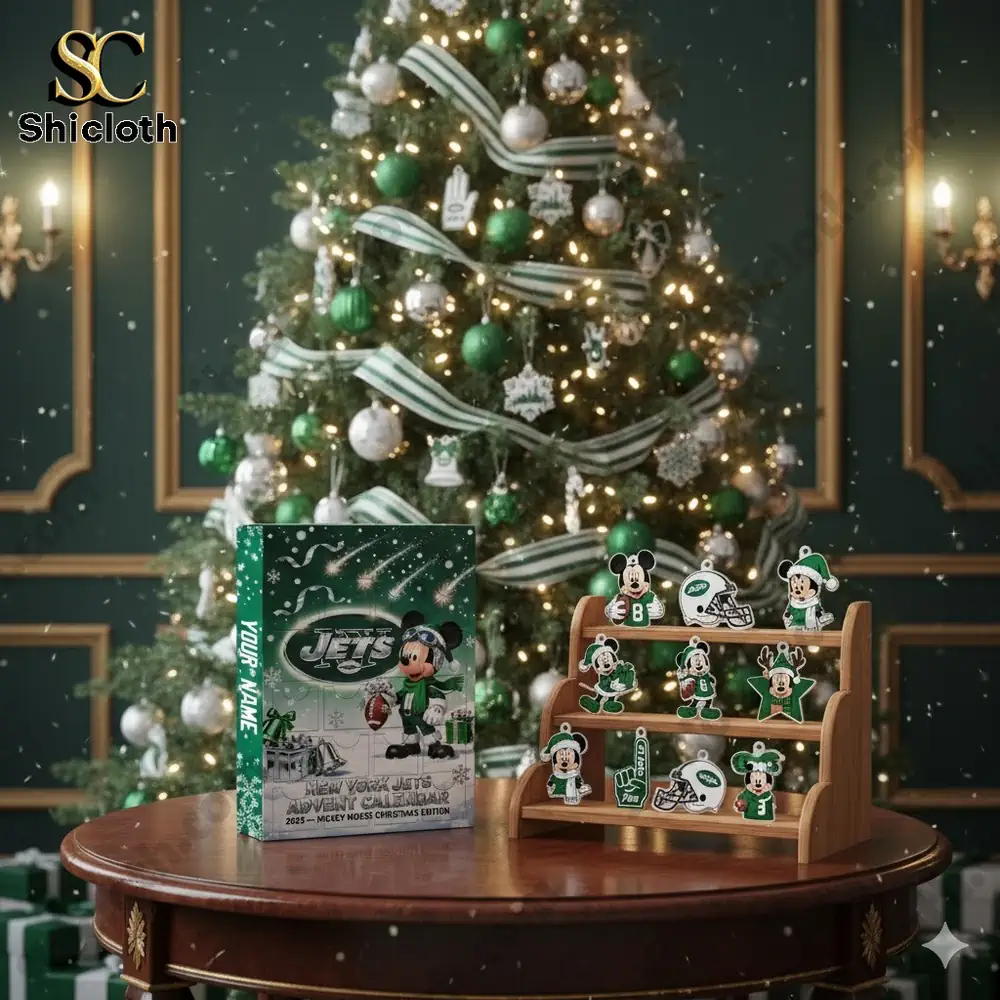 A Christmas tree decorated with New York Jets ornaments beside a Shicloth Advent Calendar displayed on a wooden table.