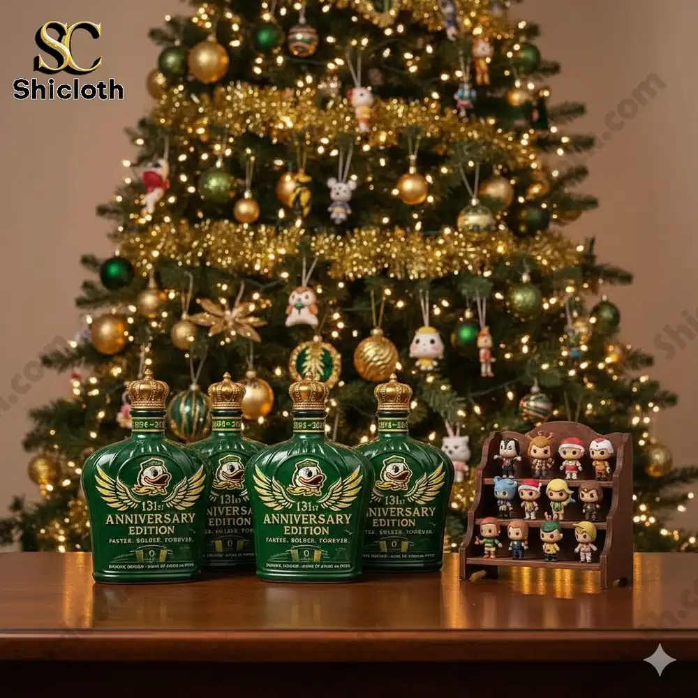 Four green anniversary edition bottles displayed on a wooden table in front of a decorated Christmas tree with small collectible figures beside them.