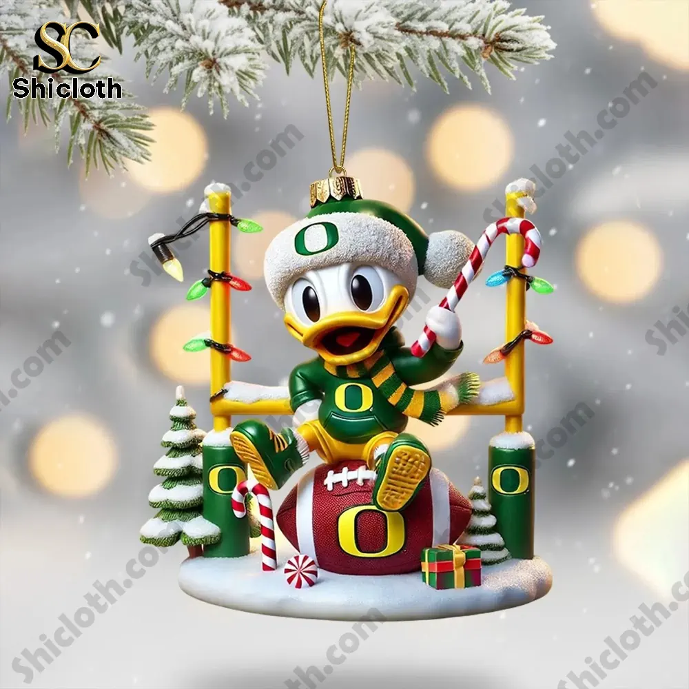 Oregon Ducks duck ornament sitting on a football with holiday decorations.