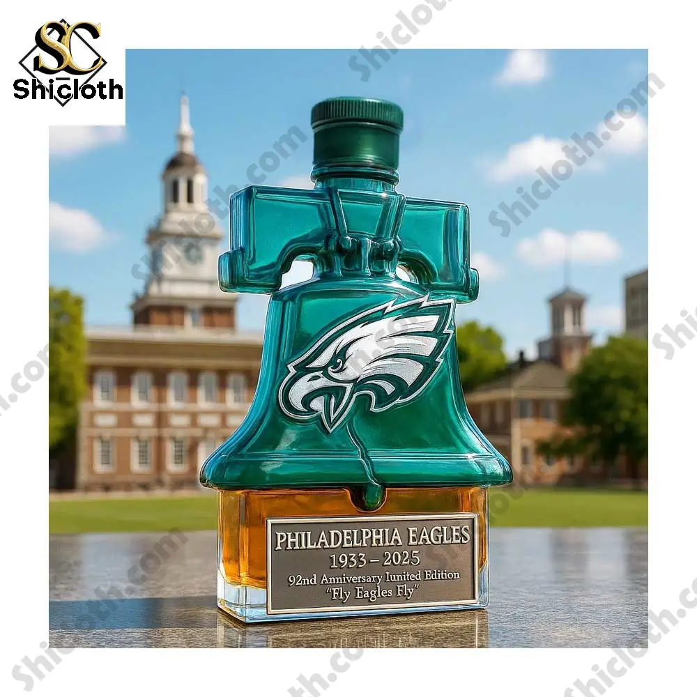 Philadelphia Eagles anniversary bottle shaped like a Liberty Bell displayed outdoors near a historic building.