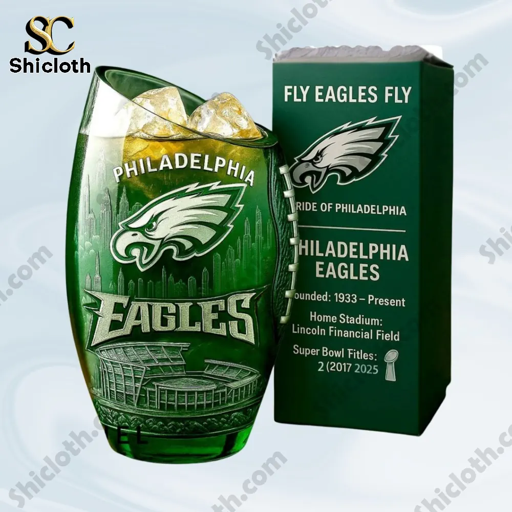 A green Philadelphia Eagles glass filled with ice next to its branded product box.