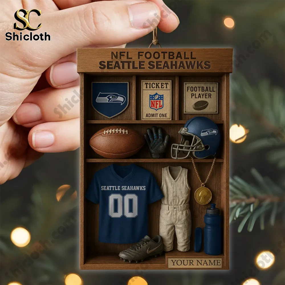 Seattle Seahawks NFL Football Locker Customizable Hanging Ornament 6 Hand holding a Seattle Seahawks locker ornament near a Christmas tree.