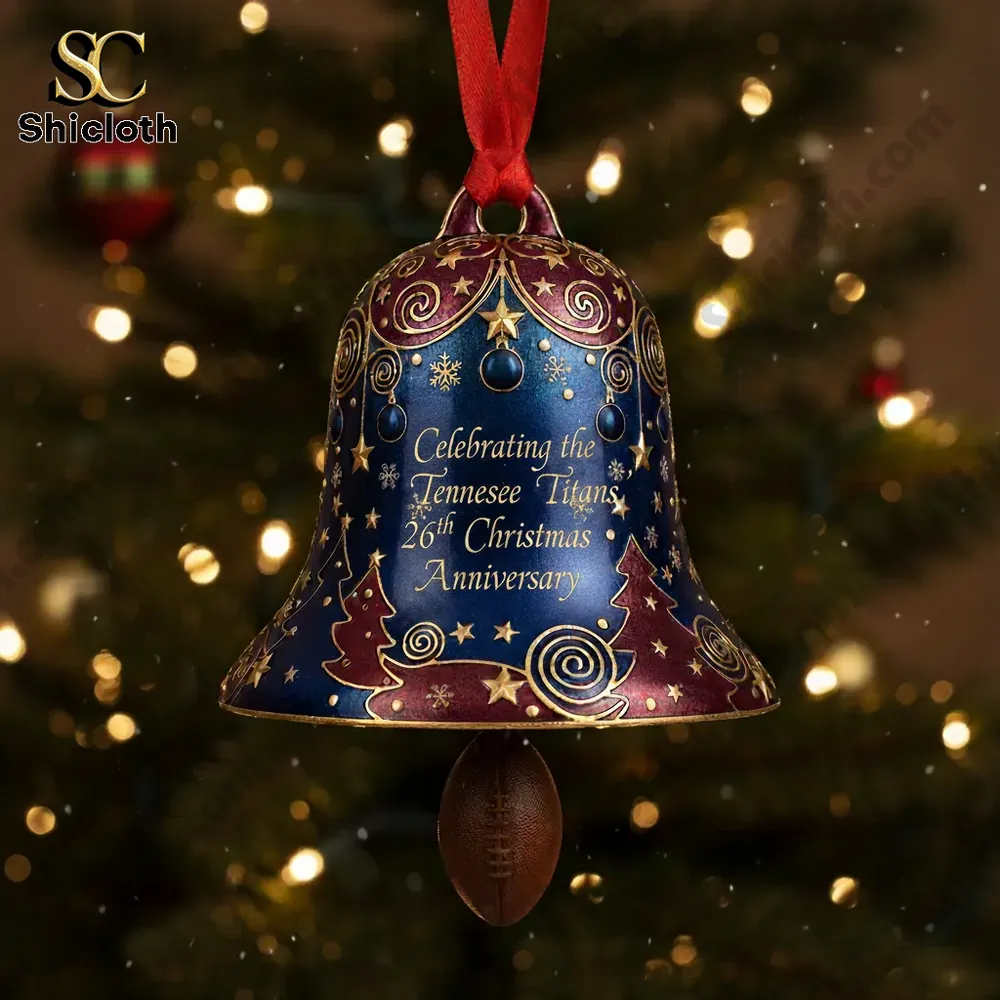 Close up of a Tennessee Titans 26th anniversary Christmas bell ornament with gold patterns and red ribbon!