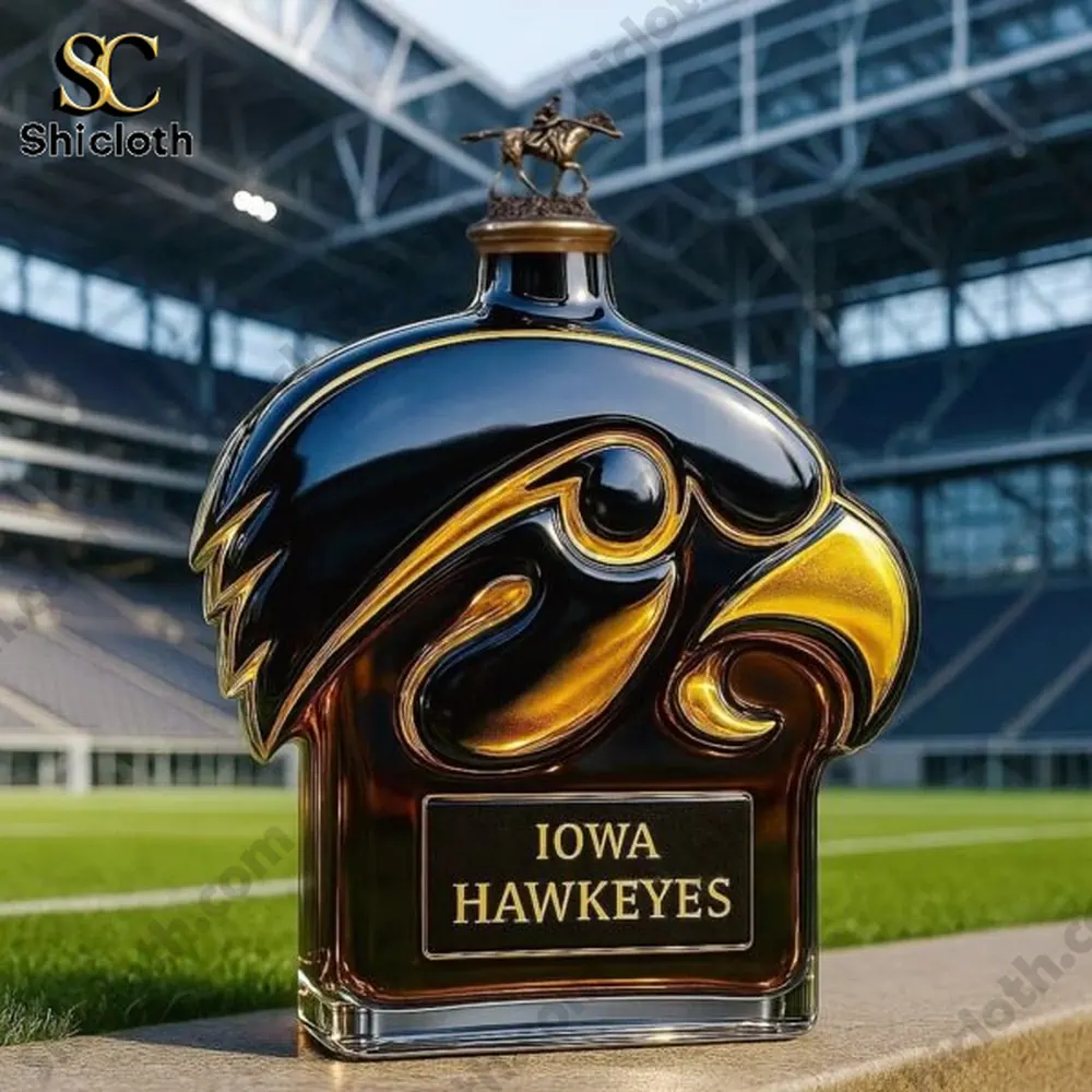 Iowa Hawkeyes logo bottle with a rider statue cap displayed on the edge of a football field inside a stadium!