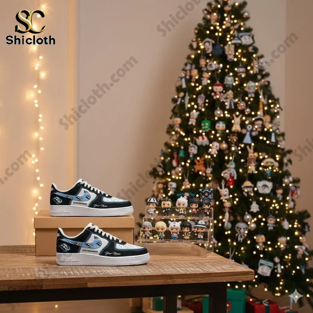 Black and white custom sneakers displayed on a wooden table near a decorated Christmas tree.
