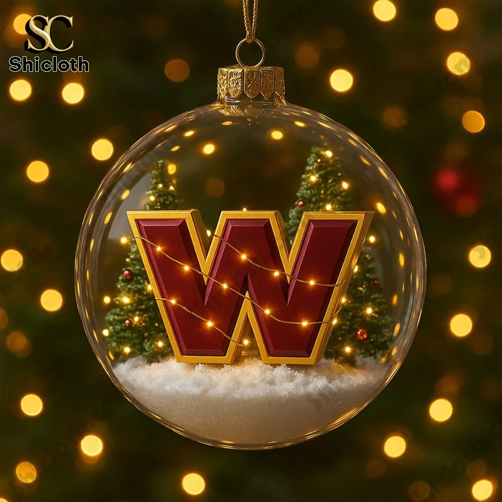 Clear ornament with a W logo and snowy trees inside.
