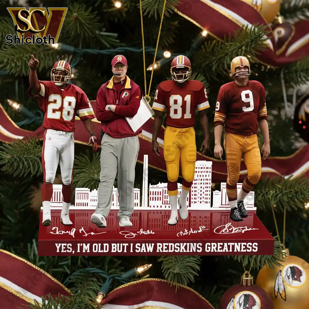 Close-up of the Redskins greatness ornament with four figures, including players and a coach, under a Christmas tree.
