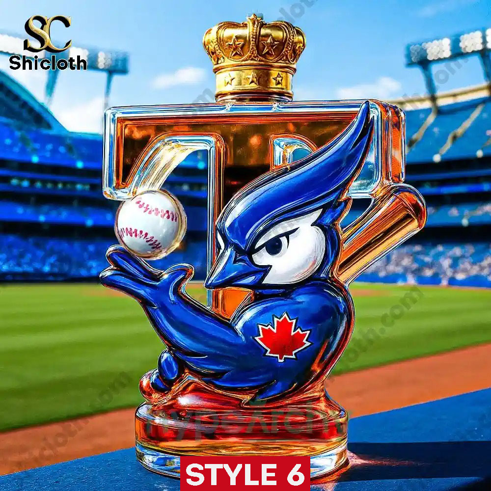 Toronto Blue Jays 2x World Series Champions Commemorative Whiskey Bottle 1 A blue jay themed liquor bottle with a gold crown cap and maple leaf logo displayed on a baseball field!