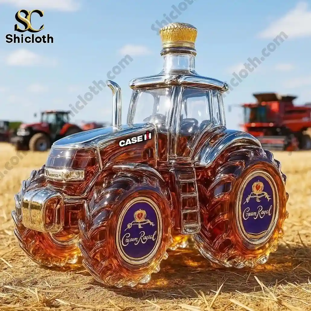 Glass tractor shaped bottle filled with Crown Royal whiskey displayed on a field.