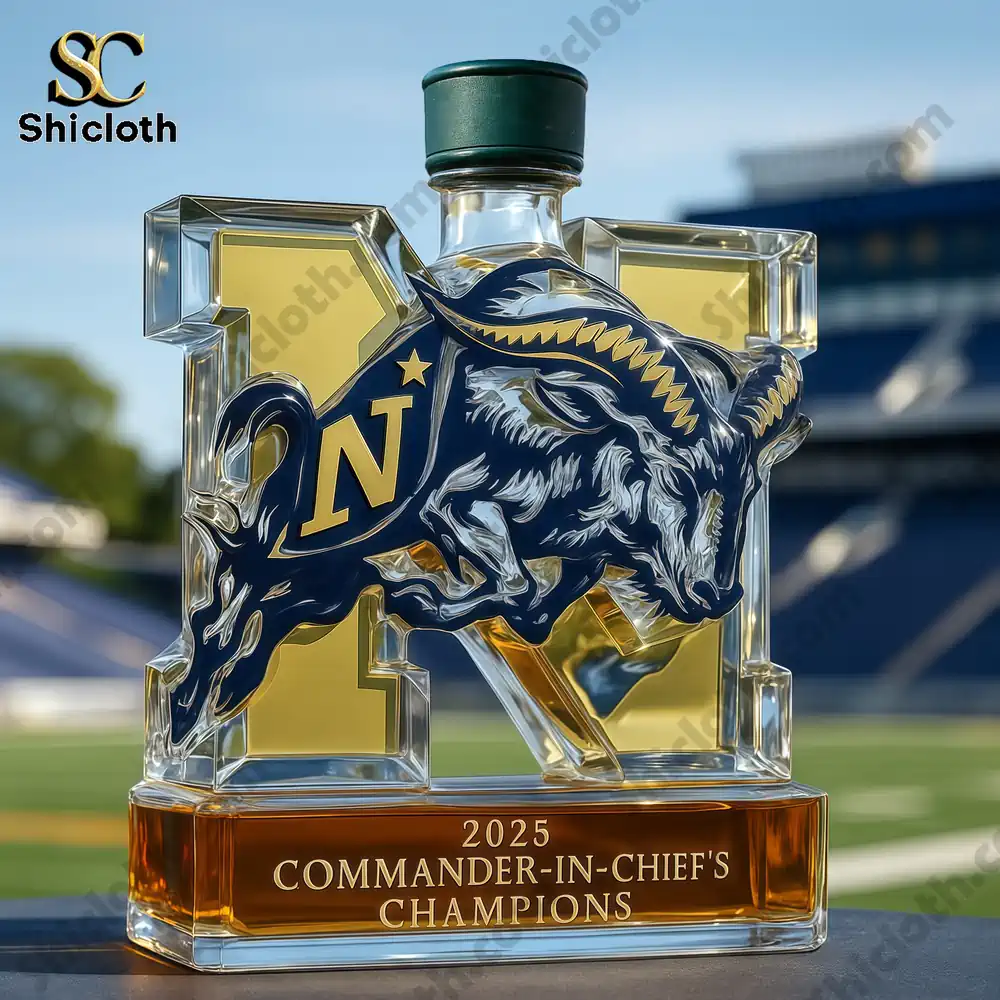 A Navy trophy whiskey bottle outdoors with a clear sky and football stadium background.