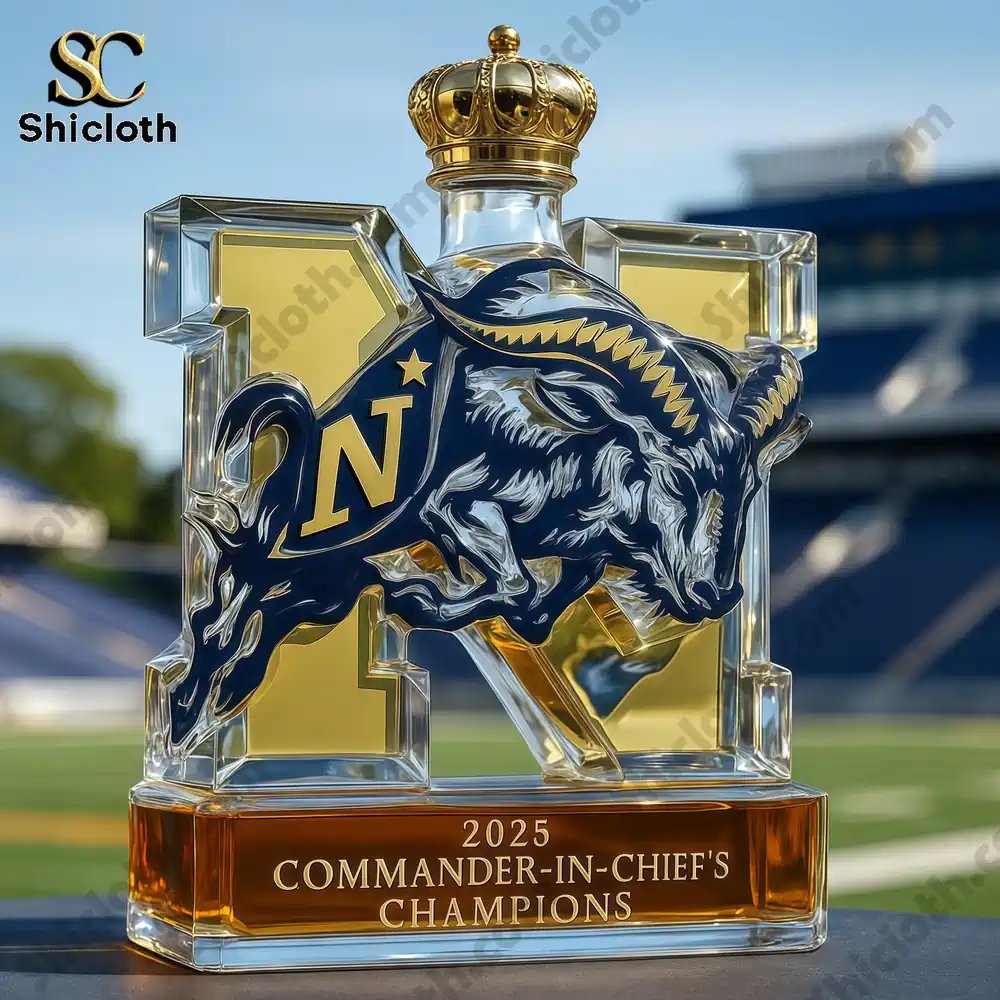 2025 Navy Commander-in-chief’s Champions Whiskey Bottle 4 A Navy trophy whiskey bottle with a crown-shaped cap displayed in front of a football stadium.