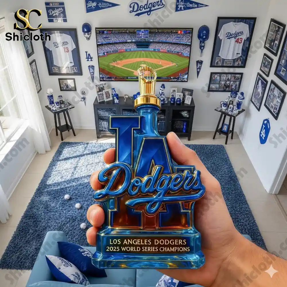 A hand holds a Los Angeles Dodgers championship styled display in a fan room filled with team memorabilia!
