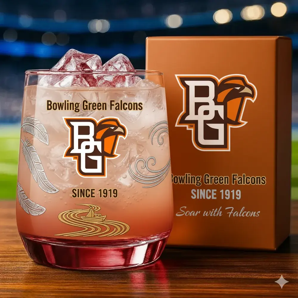 Bowling Green Falcons Christmas Whiskey Glass 3 A Bowling Green Falcons glass with ice placed near its matching box in a stadium setting.
