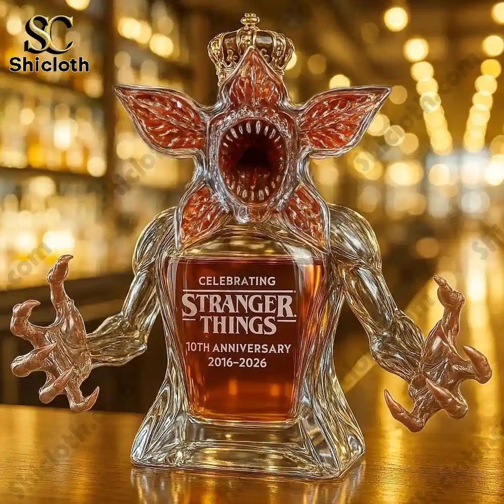 Demogorgon Celebrating Stranger Things' 10th Anniversary Whiskey Bottle Full Box 3 Demogorgon shaped bottle wearing a crown displayed on a bar counter.