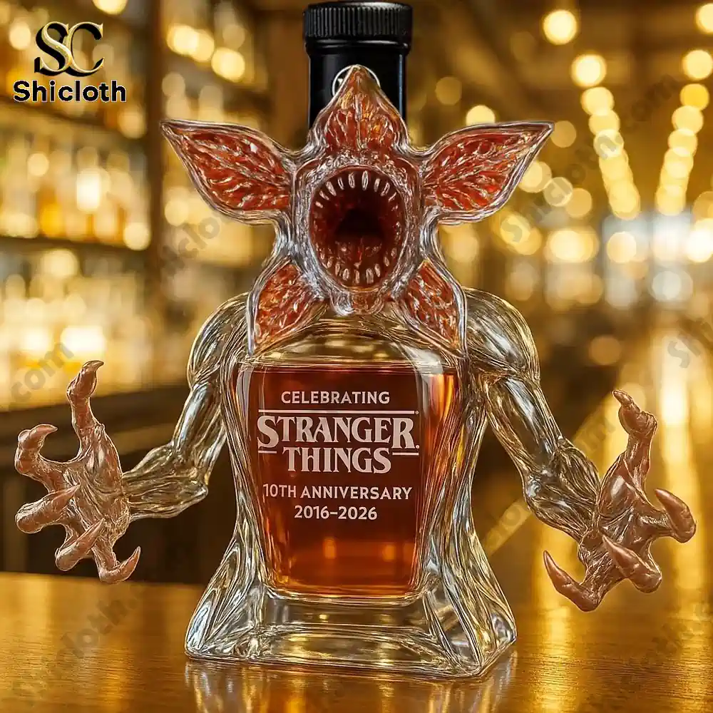 Demogorgon Celebrating Stranger Things' 10th Anniversary Whiskey Bottle Full Box 4 Demogorgon shaped bottle with a dark cap on a bar surface.