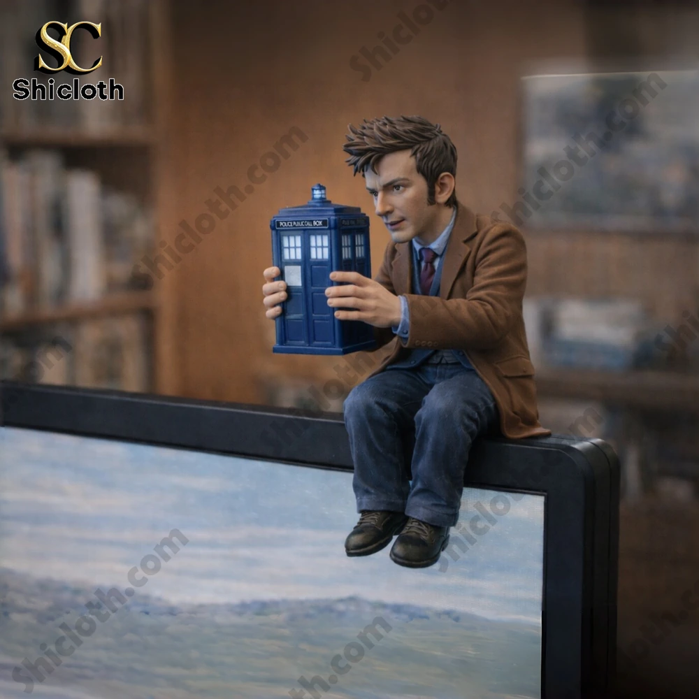 Doctor Who inspired figurine holding blue box on monitor!