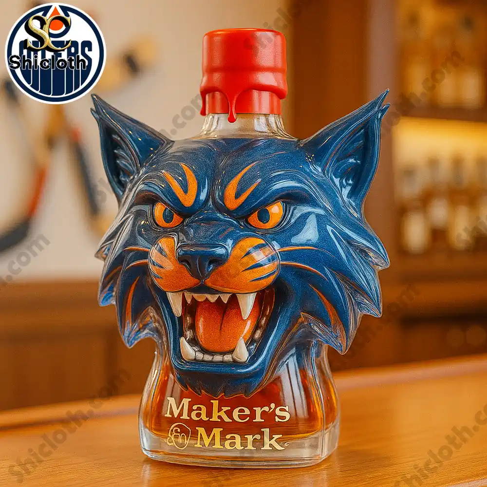 A blue orange mascot head bottle labeled Makers Mark displayed on a wooden surface.